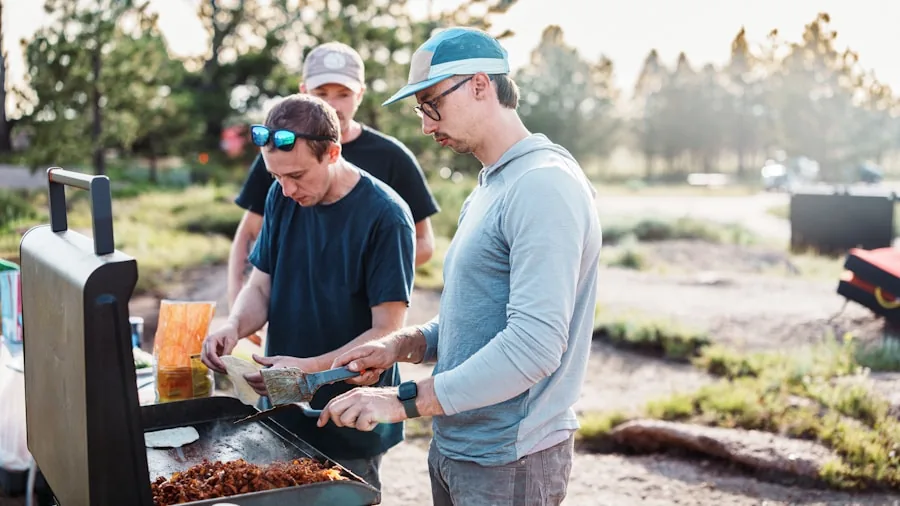 Family enjoying a meal together at an outdoor gathering with food and drinks on the table