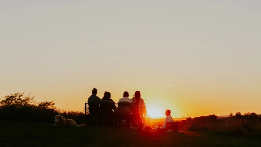 Family enjoying food around a pellet grill during golden hour outdoor dinner party