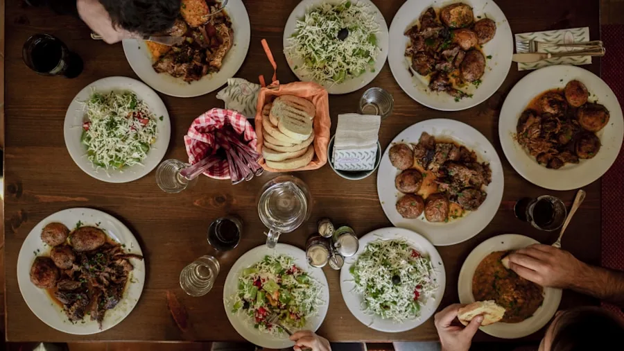 Family gathered around wooden dining table sharing a meal in warm, natural lighting
