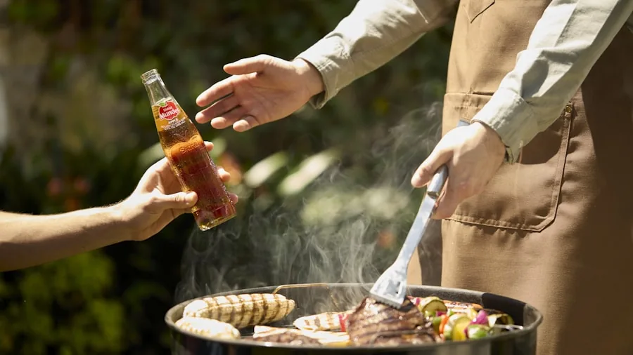 The %product_count% Best Pellet Smokers 3 Family gathering around outdoor grill preparing food together in backyard during summer meal preparation
