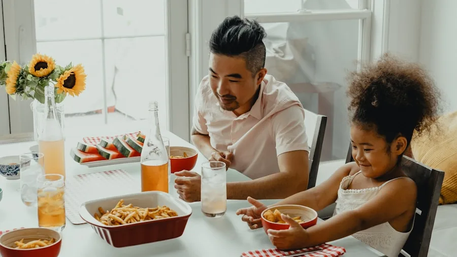 Family members clearing plates from dinner table, demonstrating lightweight dinnerware handling and daily kitchen routine
