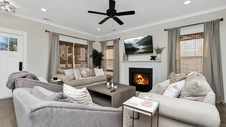 Family sitting on couch watching TV together in modern living room with comfortable seating arrangement