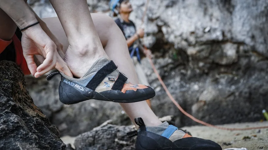 The %product_count% Best Climbing Shoes 4 Female climber checking the fit and comfort of her climbing shoe while preparing for a climb