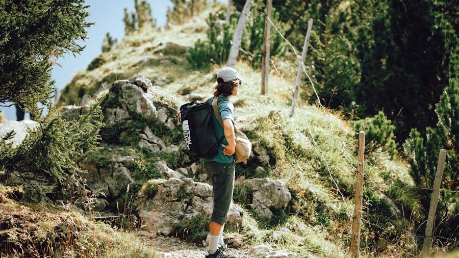 Female hiker navigating uneven rocky terrain on mountain trail wearing supportive hiking boots