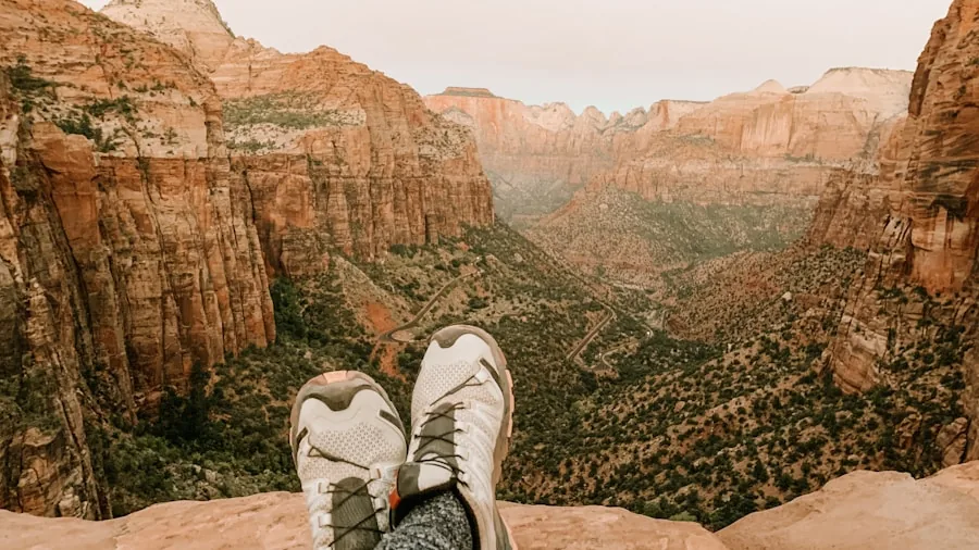 Female hiker walking on rocky mountain trail wearing durable hiking boots