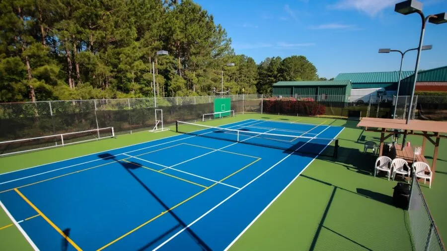 Female player making quick lateral movement on pickleball court during active rally