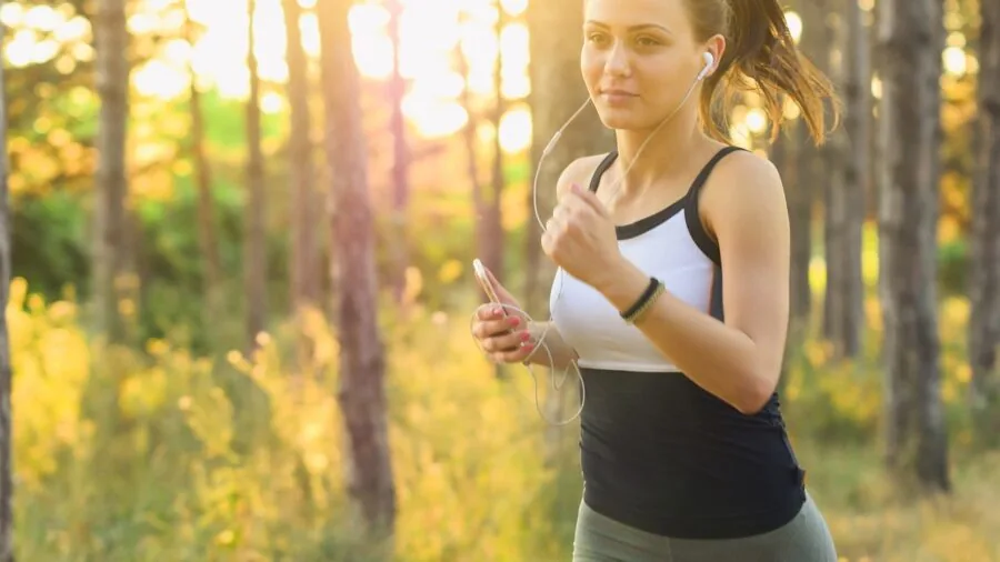 The %product_count% Best Sports Bras for Running 6 Female runner jogging on sunny path wearing athletic gear