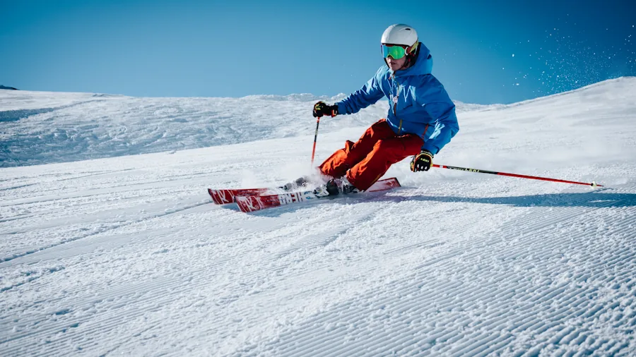 The %product_count% Best Ski Jackets for Women 4 Female skier in motion on snowy mountain slope during active winter sports