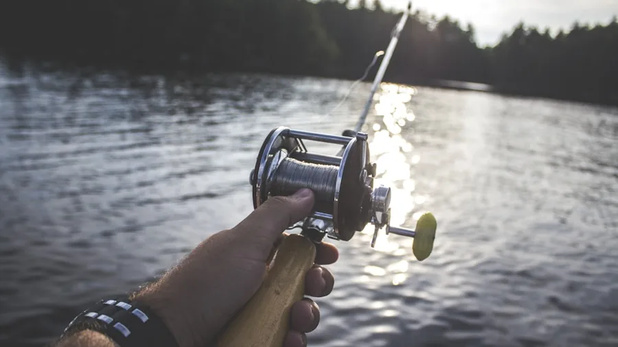 Fisherman casting line into calm water during outdoor fishing session