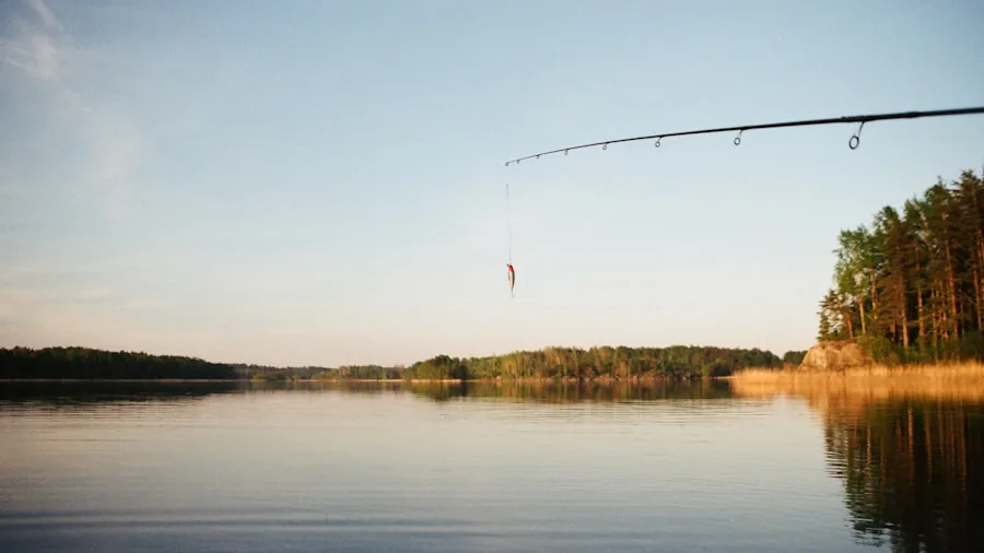 Fisherman casting rod into calm lake water during golden hour, demonstrating fishing technique
