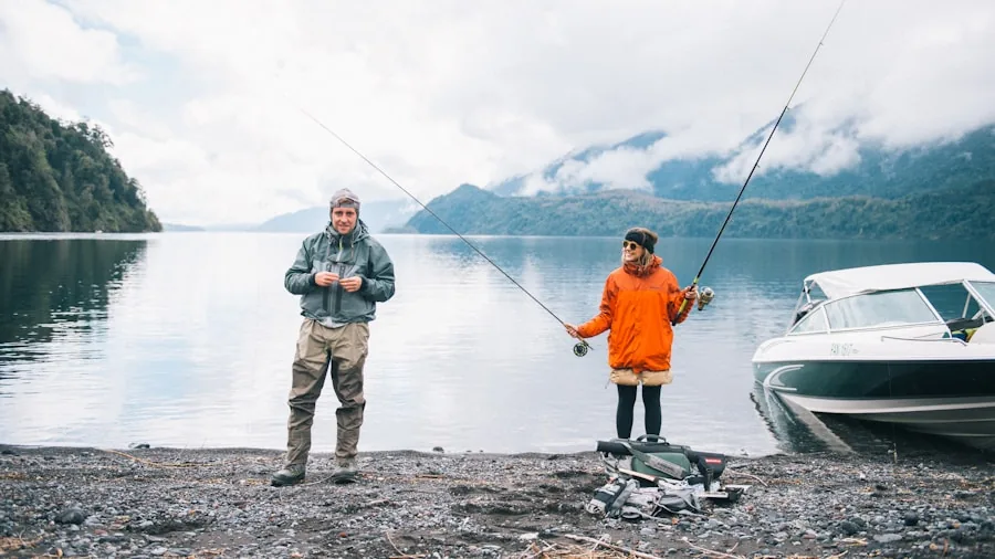 Fisherman in heavy rain gear maintaining equipment by water during wet weather conditions