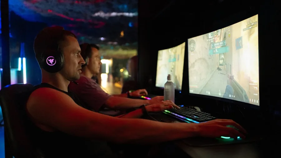 Focused gamer using laptop for gaming with concentrated expression