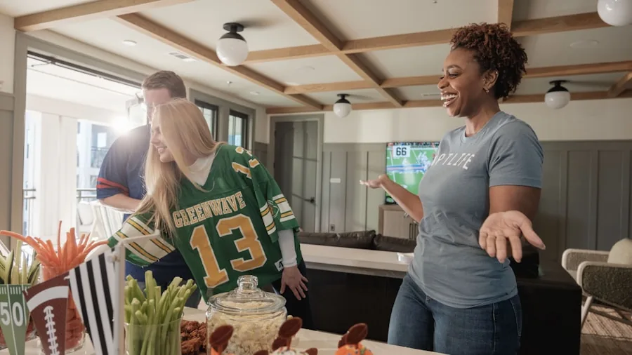 7 Tips for Choosing the Perfect TV to Watch NFL Games at Home 2 football fans cheering at home
