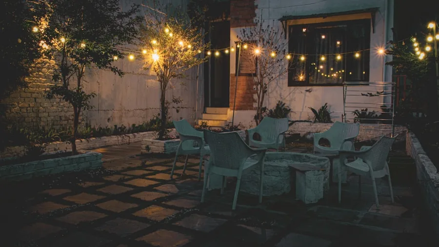 Friends enjoying a lit outdoor patio space in the evening with ambient lighting creating a warm atmosphere