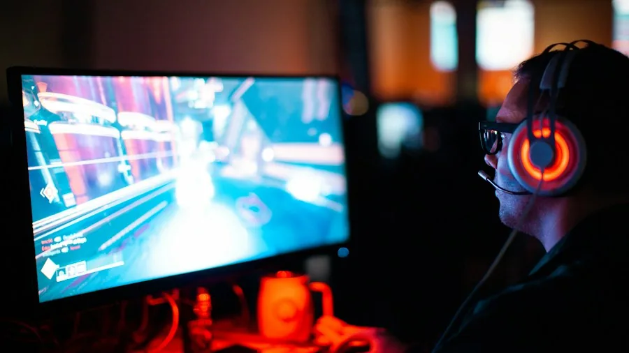 LG 48 Inch OLED Gaming TV Drops to $699.99 at Best Buy 2 gamer playing video game on TV