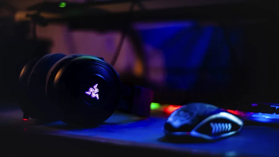 Gamer playing video game with audio headset in immersive gaming environment