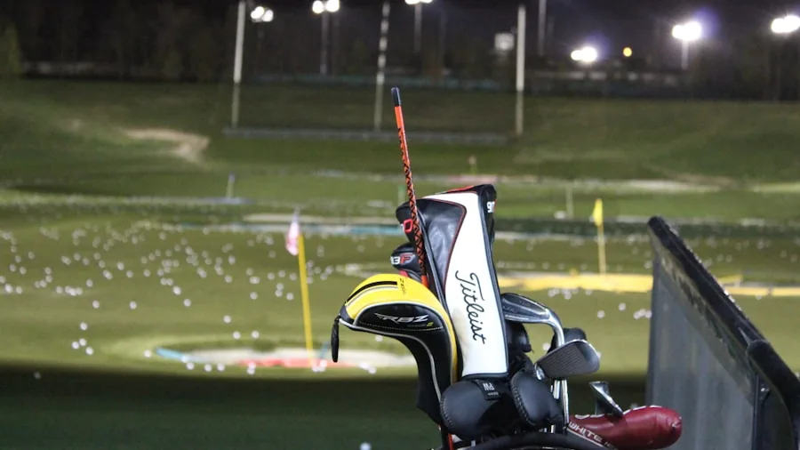 Golfer walking across golf course while carrying golf bag over shoulder during round
