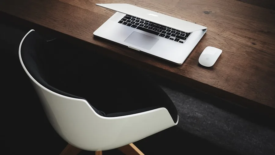 Graphic designer working at desk with laptop and design tools in creative workspace