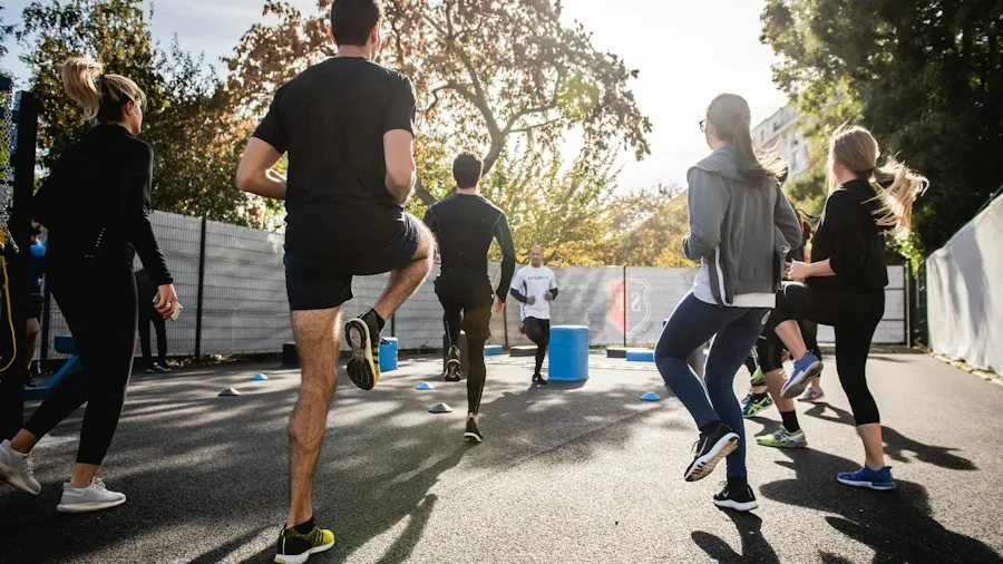 Romantasy Fitness Workouts Are Surging Among Women: What Buyers Need to Know 3 group fitness community class together