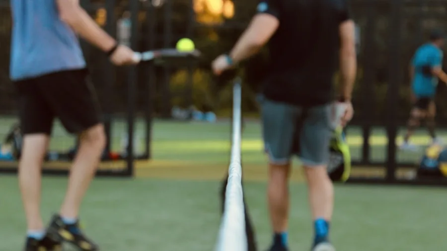 The %product_count% Best Pickleball Paddles for Beginners 4 Group of friends enjoying a casual pickleball match on an outdoor court on a sunny day
