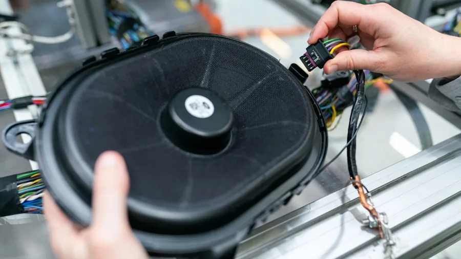 7 Tips to Fix Your Bluetooth Speaker and Restore Great Sound 2 hands adjusting volume controls on speaker