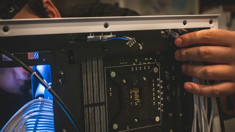 hands assembling computer components