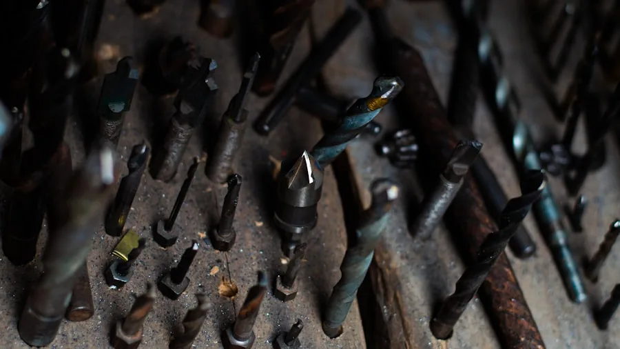 Hands examining various drill bits and chuck sizes in a home workshop setting