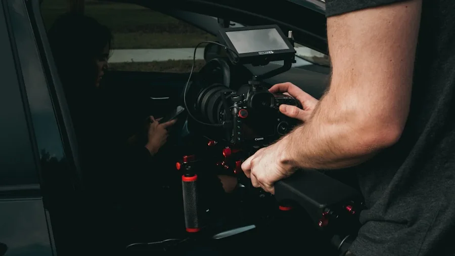Hands installing car speaker with tools in vehicle door panel