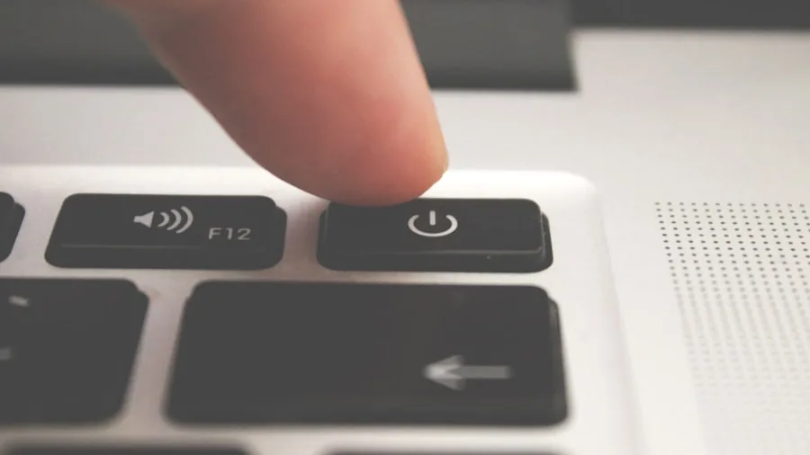 New AI Hardware Box Could Eliminate the Need to Upgrade Your Laptop 2 hands touching hardware device button with laptop screen