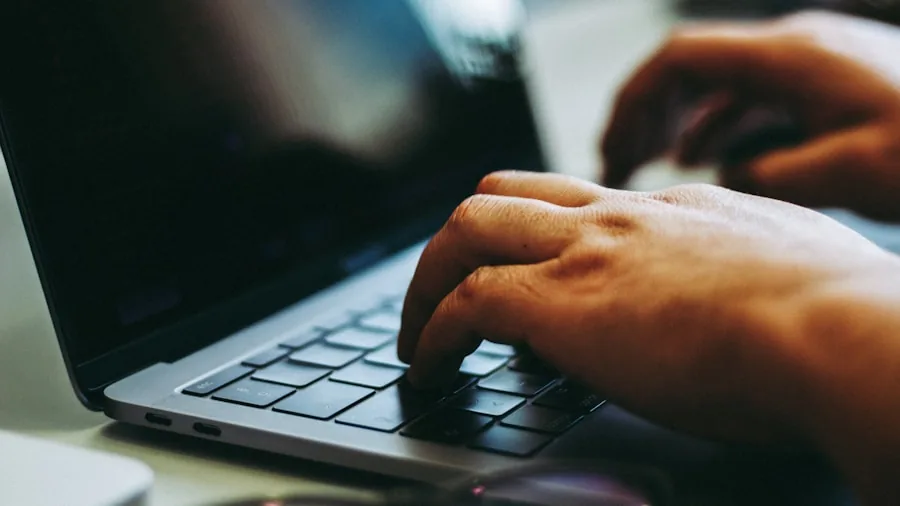 Dune Keypad for MacBook: What Buyers Should Know About This New AI-Focused Accessory 2 hands typing MacBook keyboard desktop