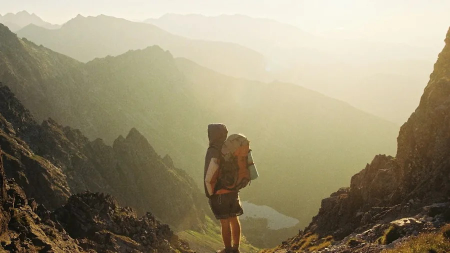 New Study Reveals Heavy Hiking Packs Damage Your Feet: What You Need to Know Before Your Next Trek 3 hiker packing backpack carefully
