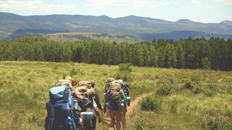 Hiker with compact daypack on mountain trail during outdoor adventure