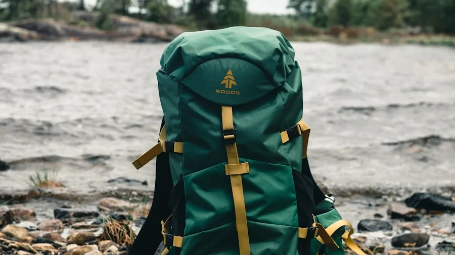 Hiker with folded camping chair in backpack on forest trail