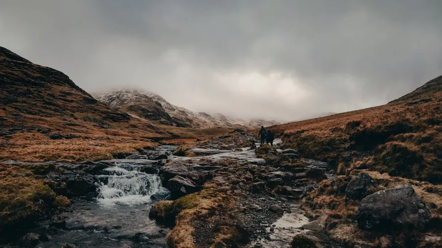 The %product_count% Best Trekking Boots 3 Hiker's boots crossing a shallow mountain stream during trek through misty landscape