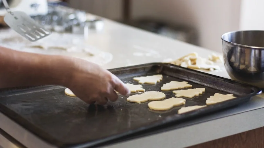 The %product_count% Best Baking Sheets 3 Home baker arranging cookie dough on baking sheet in bright kitchen