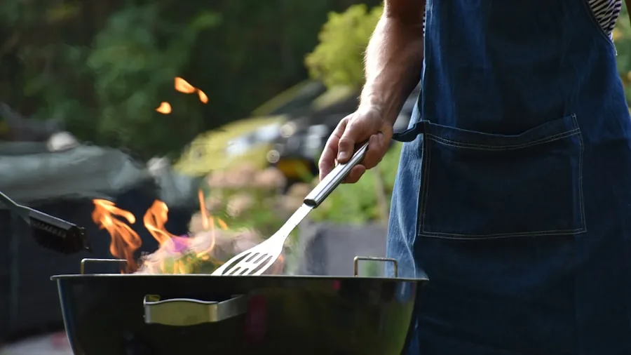 Home cook preparing food on outdoor grill in backyard during casual meal preparation