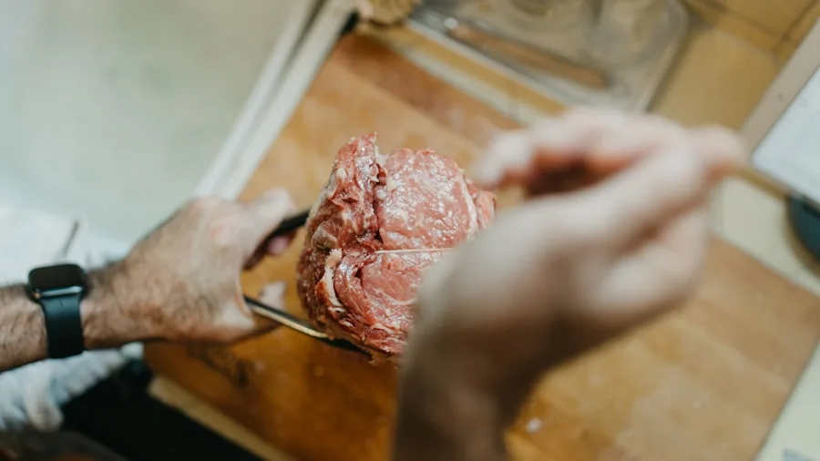 Home cook using meat thermometer to check doneness of steak on grill