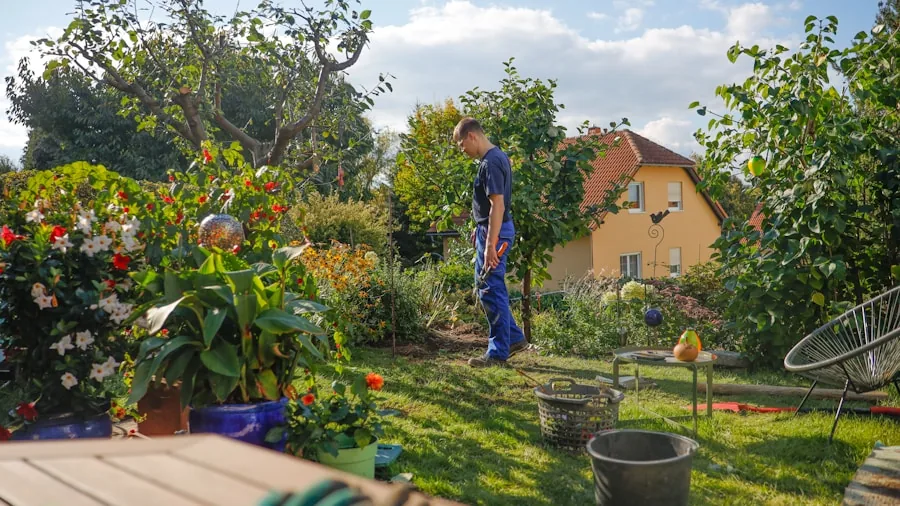Homeowner mowing grass in backyard with trees and flowers visible