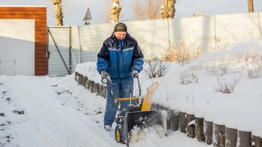 The %product_count% Best Snow Shovels 3 Homeowner using wide snow shovel to clear residential driveway efficiently during winter