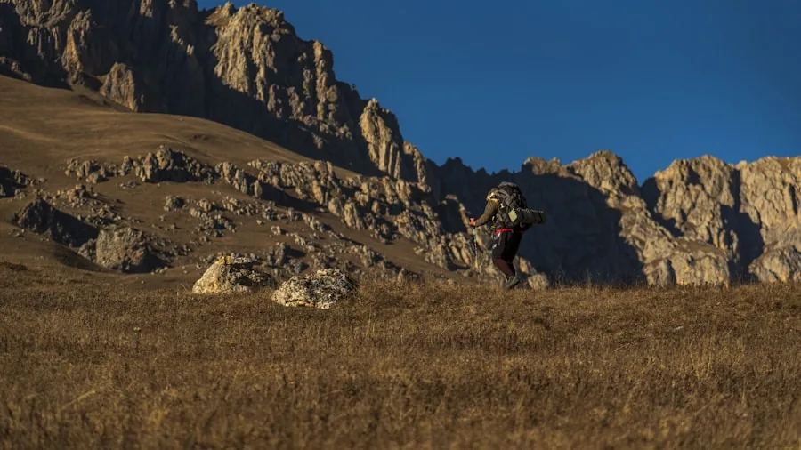 The %product_count% Best Hunting Rangefinders 6 Hunter navigating rocky mountain terrain with gear in harsh weather conditions