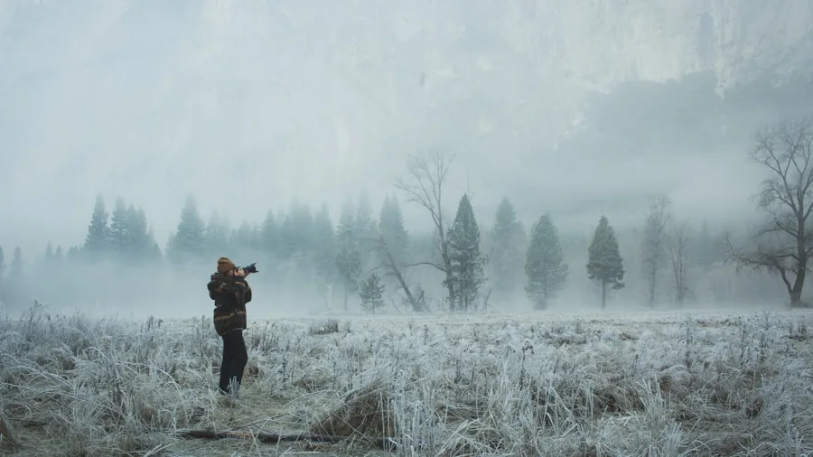 Hunter wearing insulated boots standing in snowy forest landscape during cold weather hunt