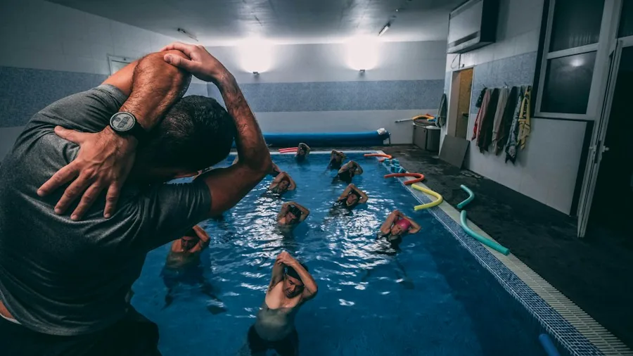 Group Fitness Class Problems: 4 Strategies to Maximize Your Results 2 instructor helping participants form correction