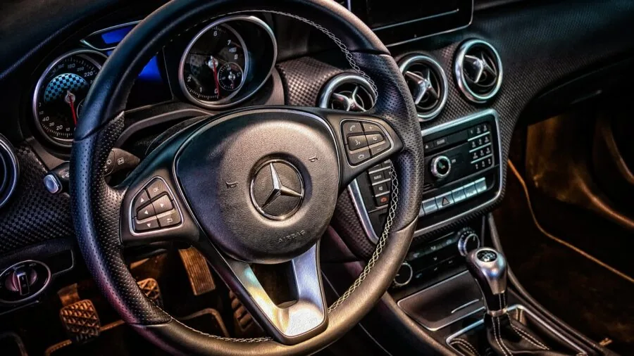 Interior car dashboard exposed to intense summer sunlight through windshield