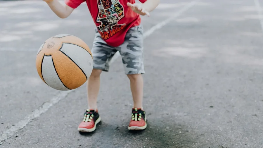 Kids playing basketball together in a sunny backyard during active outdoor recreation