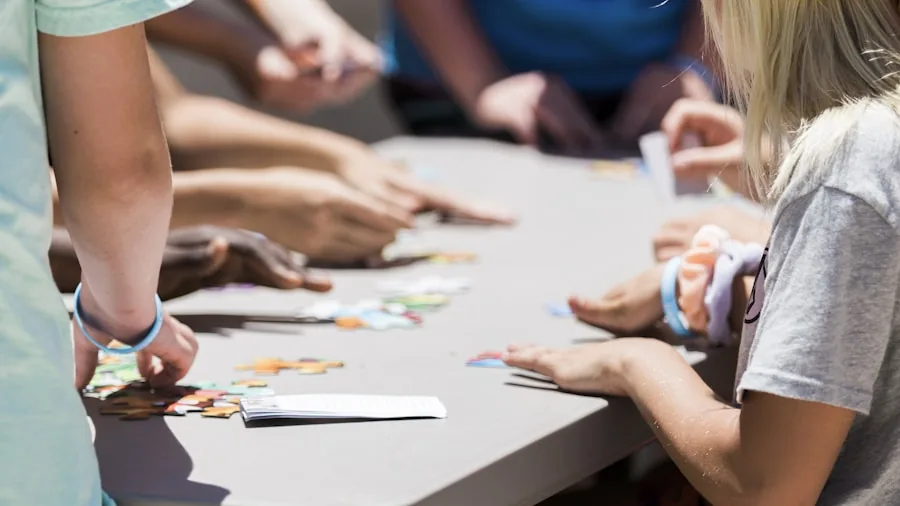Kids sitting around table playing board game, focusing on game pieces and engaged faces
