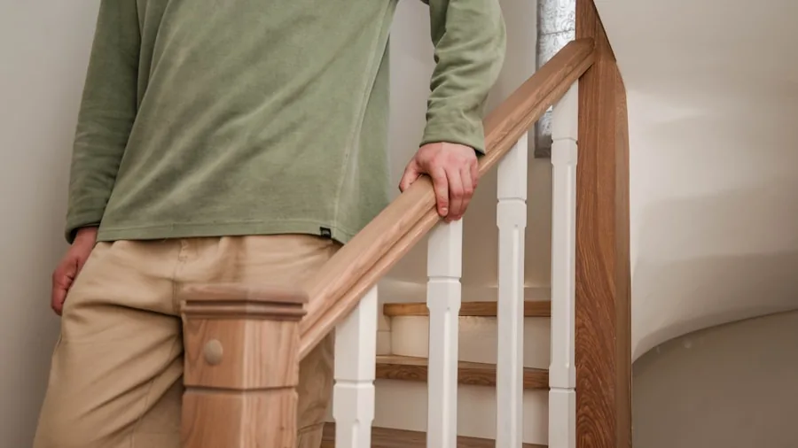 The 15 Best Cordless Vacuums 5 Person using vacuum attachments to clean residential stairs in a lived-in home environment