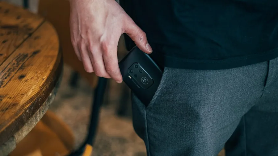Male athlete jogging outdoors checking smartphone secured in shorts pocket
