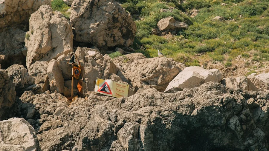 The %product_count% Best Kayaks for Fishing 4 Man carrying kayak across uneven ground toward water launch point