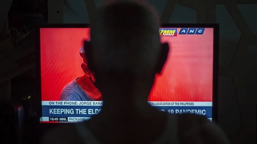 Man intensely watching fast-paced sports game on TV screen in living room