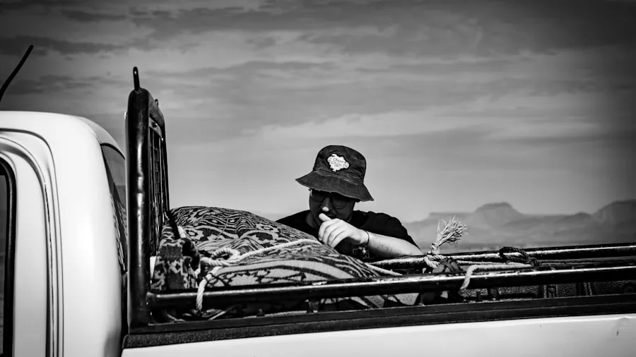 Man measuring truck bed dimensions with tape measure to ensure proper tonneau cover fit